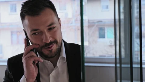Businessman smiling while talking on the phone Stock Footage 94831197