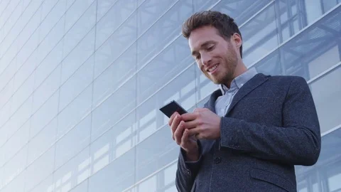 Businessman sms texting using app on smart phone in city business district Stock Footage 79898505