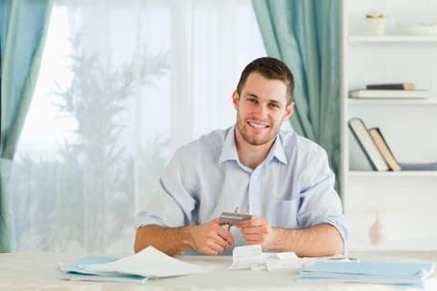 Businessman solving his problems by destroying his credit card Stock Photos