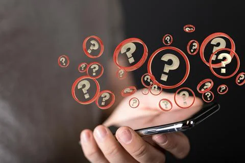 A businessman solving a problem with 3D rendering digital question marks over Stock Photos