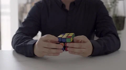 Businessman solving a rubik's cube. concept solving problems Stock Footage 250462789