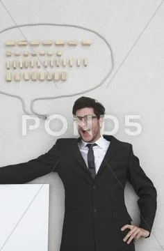Businessman with speech balloon, portrait, elevated view Stock Photos