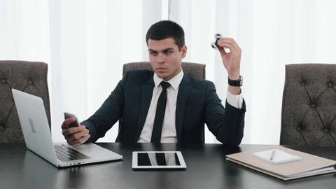 Businessman with a spinner, confident director with spinner fidget, business man Stock Footage