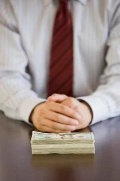 Businessman with stack of US Dollars Stock Photos