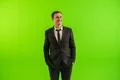 The businessman stand on the green background Photo
