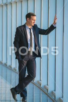 The businessman stand near the panoramic window Stock Photos