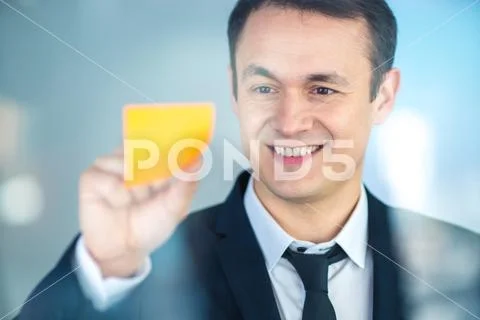 The businessman stand near a sticker on the glass Stock Photos