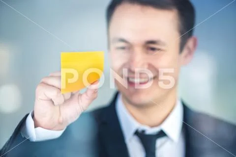 The businessman stand near a sticker on the window Stock Photos