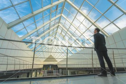 The businessman stand on the office balcony on the sky background Stock Photos