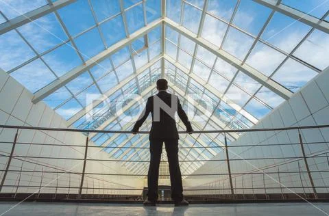 The businessman stand on the office balcony on the sky background Stock Photos