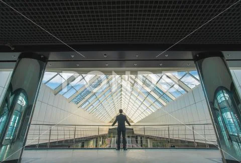 The businessman stand on the office hall Stock Photos