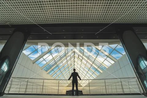 The businessman stand on the office hall Stock Photos