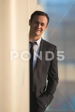 The businessman stand over the column in the business center Stock Photos