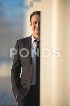 The businessman stand over the office column Stock Photos