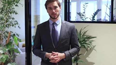 Businessman standing and talking at webcam consulting client online. Stock Footage 131648767