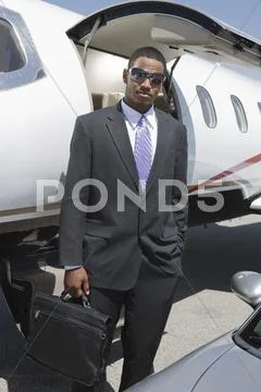 Businessman Standing With Attitude At Airfield Stock Photos