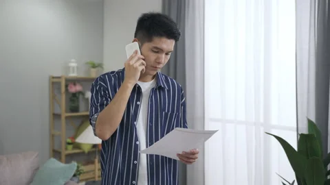 Businessman is standing checking a paperwork Video stock 163693335