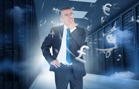 Businessman standing in data center with currency graphics Stock Photos