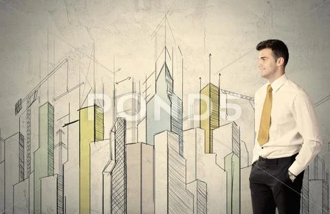 Businessman standing with drawn cityscape Stock Photos