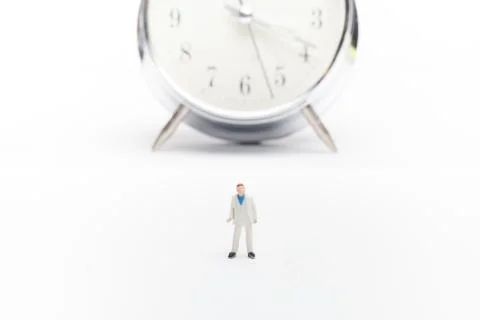 A businessman standing in front of the clock Stock Photos