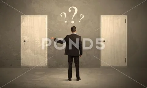 Businessman standing in front of doors Stock Photos