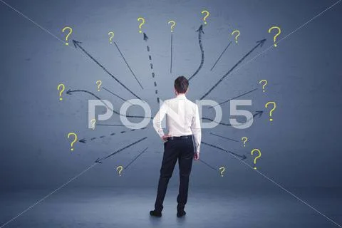 Businessman standing in front lines and question mark signs concept Stock Photos