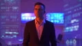 The businessman standing in the futuristic office on the hologram background 4k or 4k+ Resolution