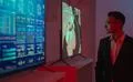 The businessman standing near screens in the dark room Photo