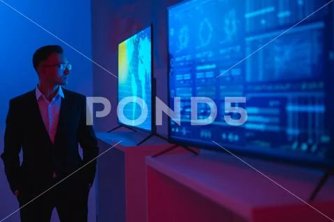 The businessman standing near screens with graphs Stock Photos