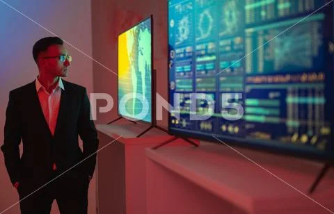 The businessman standing near screens with graphs Stock Photos