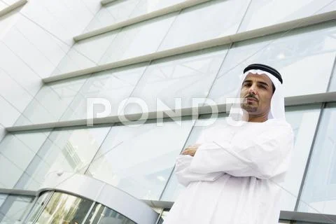 Businessman standing outdoors by building Stock Photos
