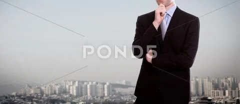 Businessman standing over a cityscape Stock Photos