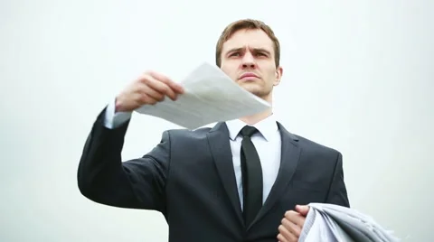 Businessman standing with a stack of paper in the wind. throwing documents Stock Footage 63895087