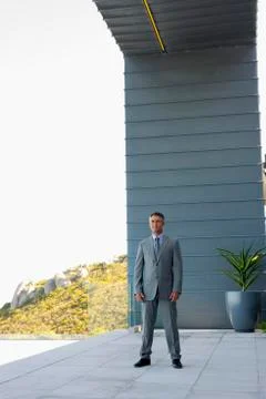Businessman standing on a terrace Stock Photos