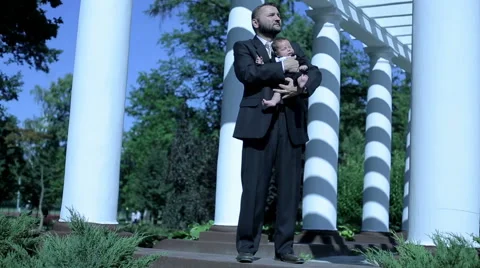 Businessman stands with child Stock Footage 59088917