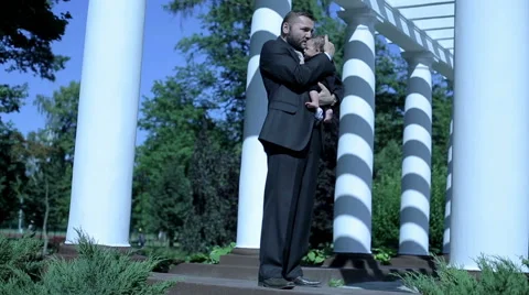 Businessman stands , hugs and kiss his child  Stock Footage 59088798