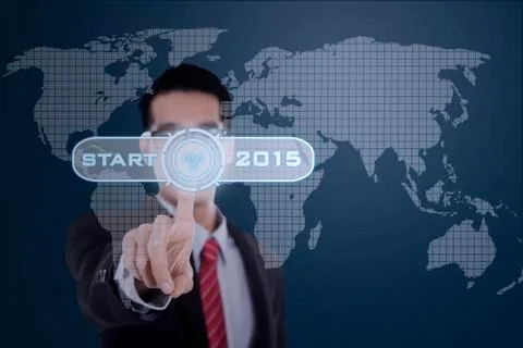 Businessman with a start button to future Stock Photos