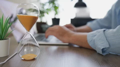 Businessman starting an hourglass countdown while working at his office des.. Stock Footage 341624081