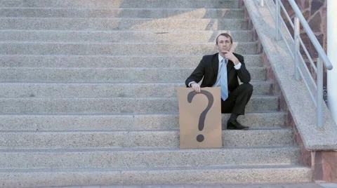 Businessman on Steps with Question Mark Sign Stock Footage 44695372