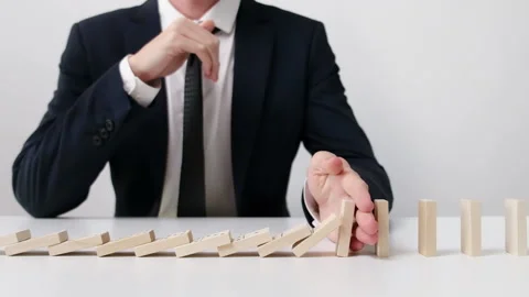 Businessman Stopped the Domino Effect. Stock Footage