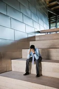 Businessman in a stressful situation while on a cell phone in the lobby of a Stock Photos