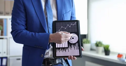 Businessman studying charts on digital tablet and showing okay gesture 4k movie Stock Footage 252649965