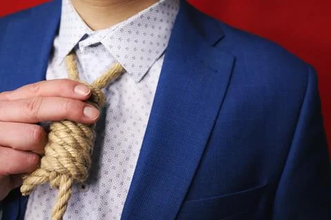 Businessman in suit with Lynch loop instead of tie over neck. Stock Photos