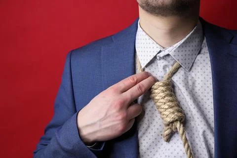 Businessman in suit with Lynch loop instead of tie over neck. Stock Photos