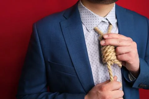 Businessman in suit with Lynch loop instead of tie over neck. Stock Photos