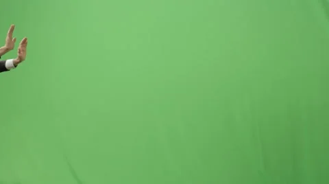 Businessman in a suit is pushing a virtual interactive wall on green screen Stock Footage 56825569