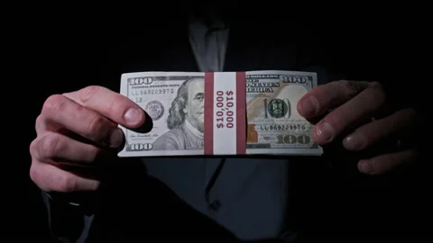Businessman in Suit Shows Stack of 10000 American Dollars on Black Background Stock Footage 170849516