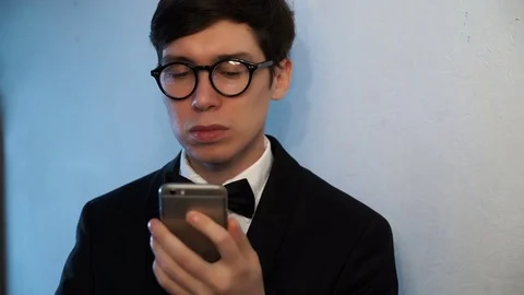 Businessman in a suit is using a smartphone. Stock Footage 75936896