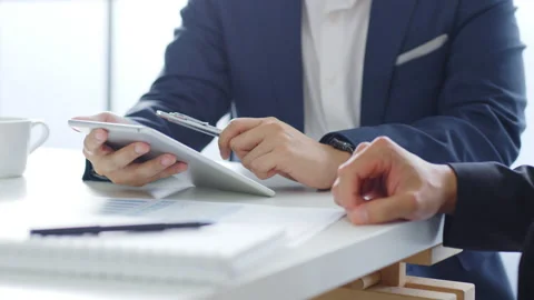 Businessman in suit using tablet working, meeting about business finance Stock Footage 144003874