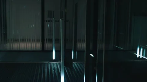 Businessman in a suit walks through an empty glass office Stock Footage 141986560